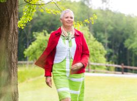 Picture of a person living with osteoporosis having a walk in a park