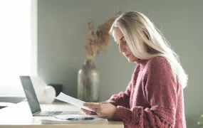 Picture of a person living with a severe disease doing administration work